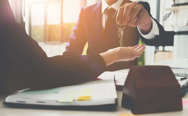 Man handing keys to client