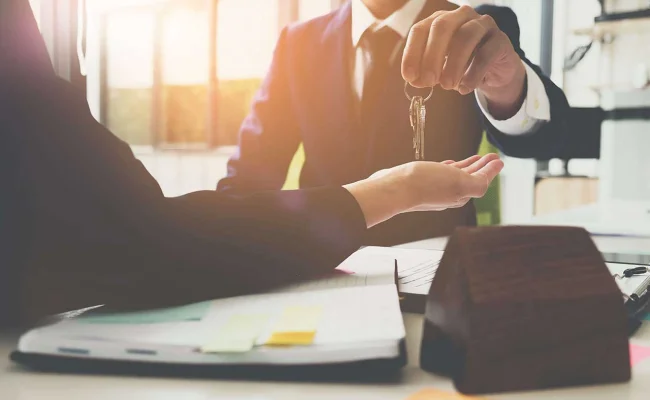 Man handing keys to client